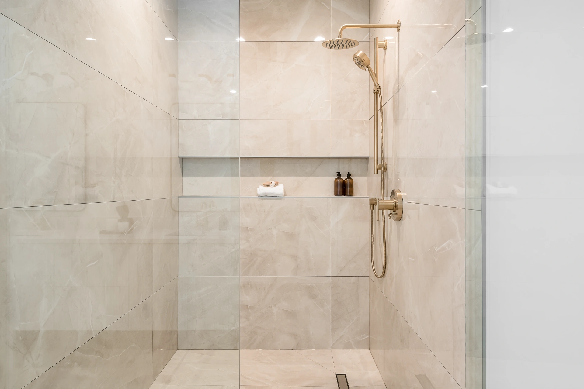 Fully tiled wet area with brushed gold shower fixtures