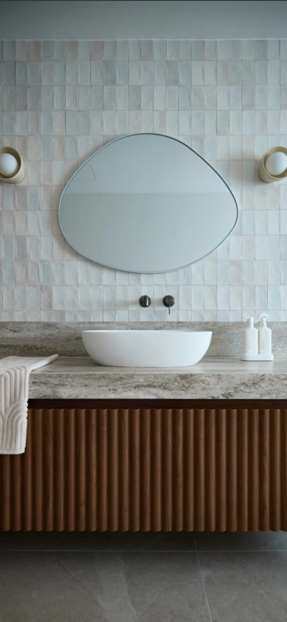 Stone-top vanity below zellige tiling in a Vincentia bathroom